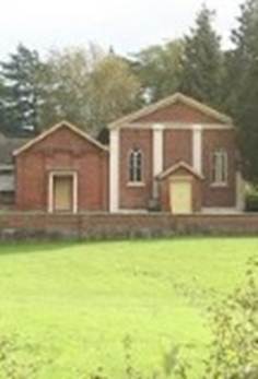 A brick building with a lawn
AI-generated content may be incorrect.