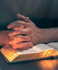 A person's hands folded over a book

AI-generated content may be incorrect.