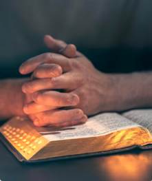 A person's hands folded over a book
AI-generated content may be incorrect.